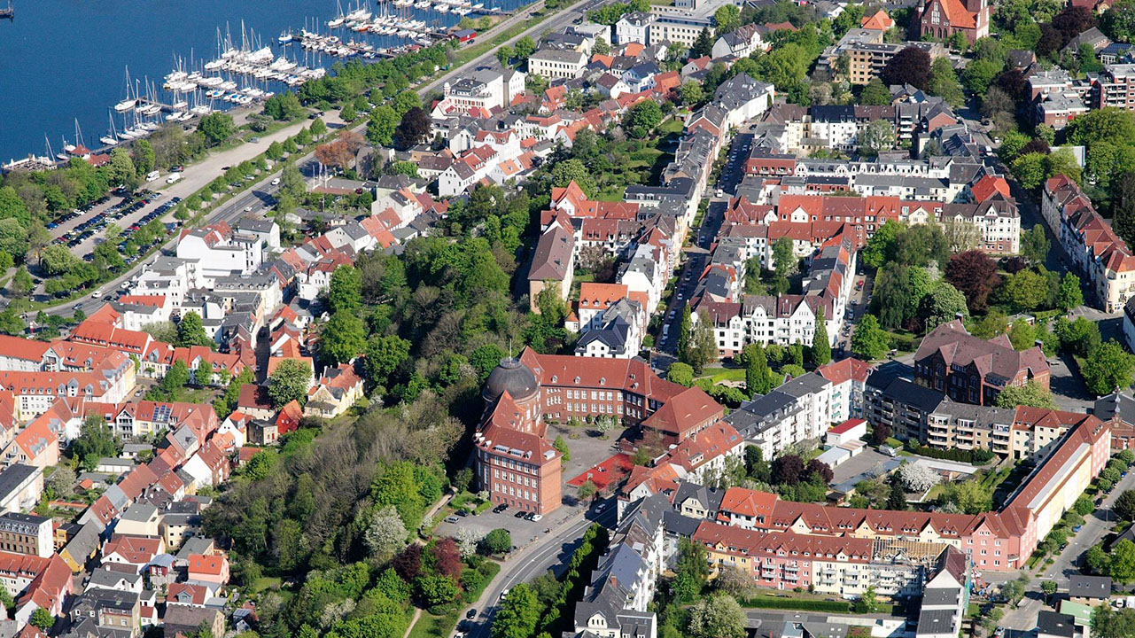 Drohnenbild der Wasserflugstation in Flensburg mit Wasserfluzeug und den Booten aus dem Bootsverleih.