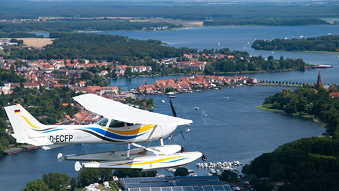 Drohnenbild der Wasserflugstation in Flensburg mit Wasserfluzeug und den Booten aus dem Bootsverleih.